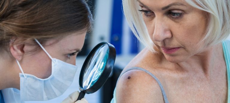 A doctor examining a woman's shoulder