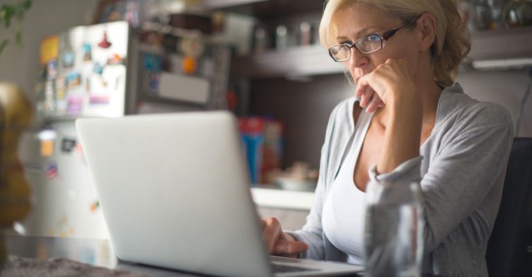 A woman reading something in the computer