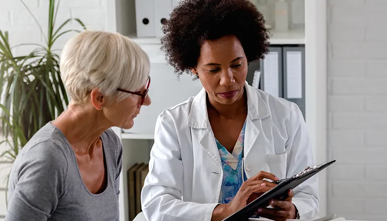 A woman seeing a document that a doctor is showing