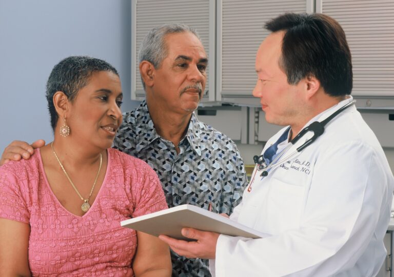 Dr consulting with a male and female patient.