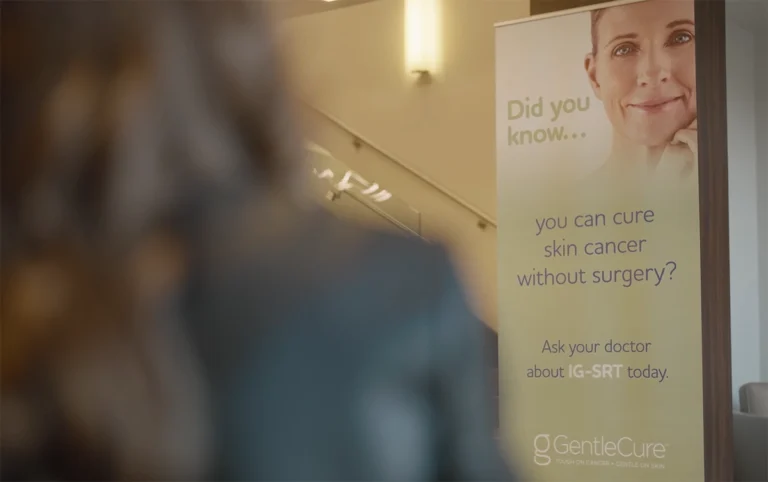 GentleCure informational banner displayed inside a clinic hallway explaining that skin cancer can be treated without surgery and encouraging patients to ask their doctor about IGSRT.